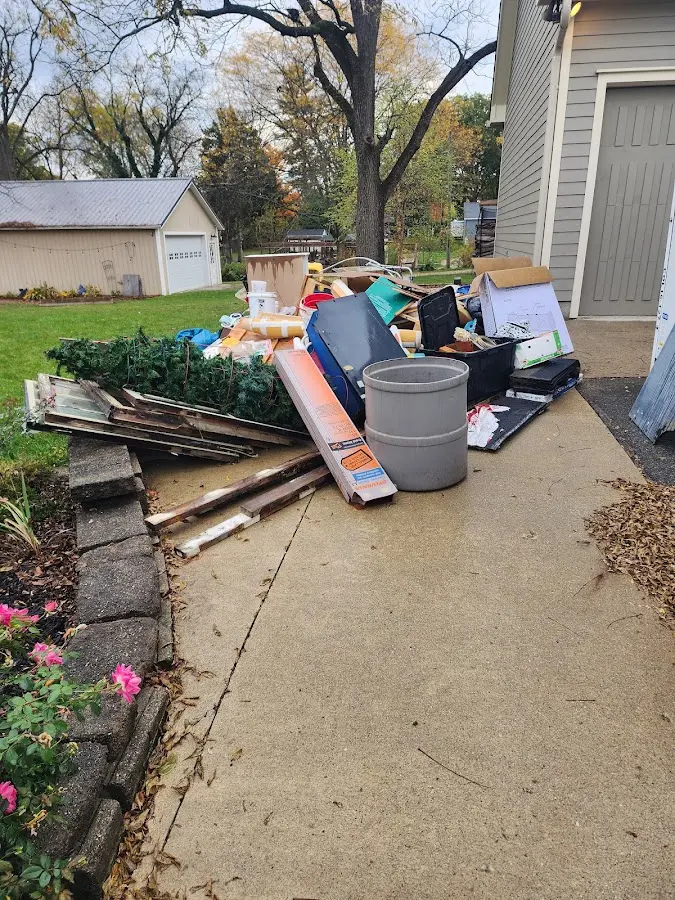 Dumpster being loaded with debris for Estate Cleanout Dumpster Rental in Westmont